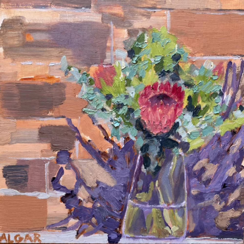 Oil painting 'Corrie's Proteas' by Tracy Algar, protea flowers in a vase against a brick wall.